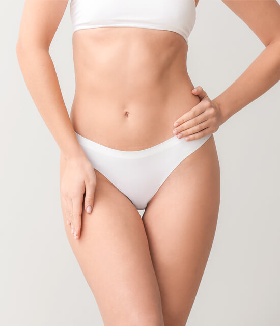 Woman in white bikini showing toned abdomen after CoolSculpting treatment body contouring fat reduction aesthetic results